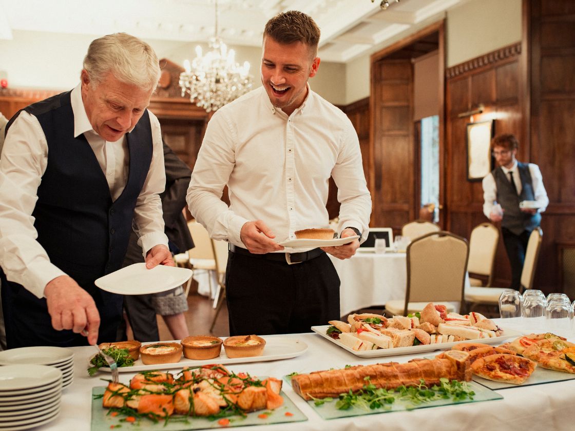 Corporate event dining setup at Pristine Woods, one of the best resorts in Dehradun for corporate events, featuring an elegant buffet with gourmet sandwiches, pastries, and salads.