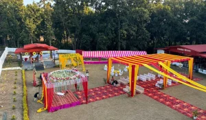 Outdoor wedding setup with vibrant decor and mandap at Pristine Woods Resort – a scenic wedding venue in Dehradun surrounded by lush forest backdrop.