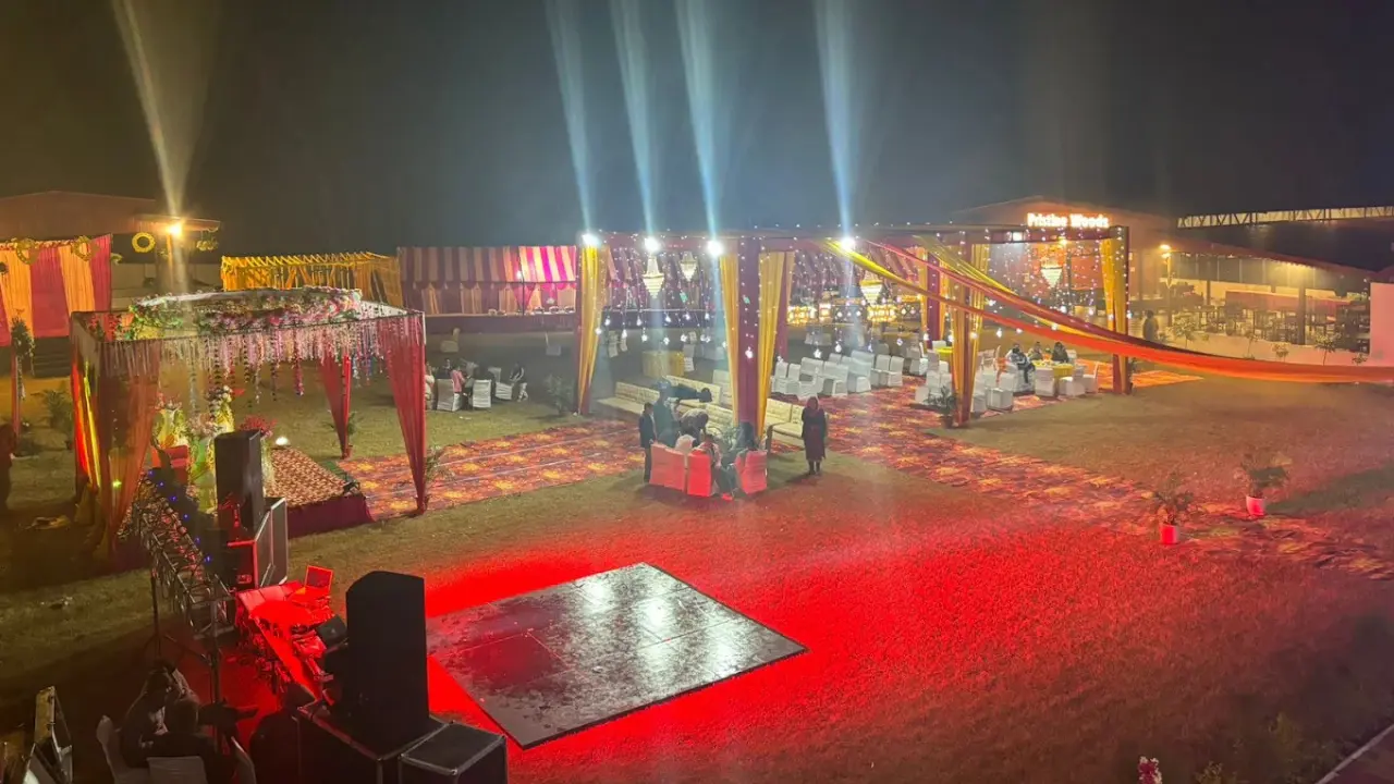 Pristine Woods Resort banquet hall in Dehradun with lush green lawn, elegant wedding stage, and golden-hour lighting, best banquet hall in Dehradun for weddings and events.