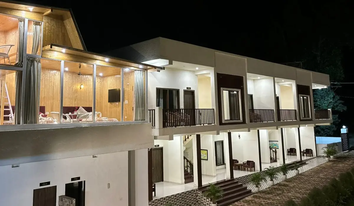 Night view of Pristine Woods Resort in Dehradun with premium cottages and balcony rooms, perfect for family stays, weddings, and luxury getaways near Sahaspur