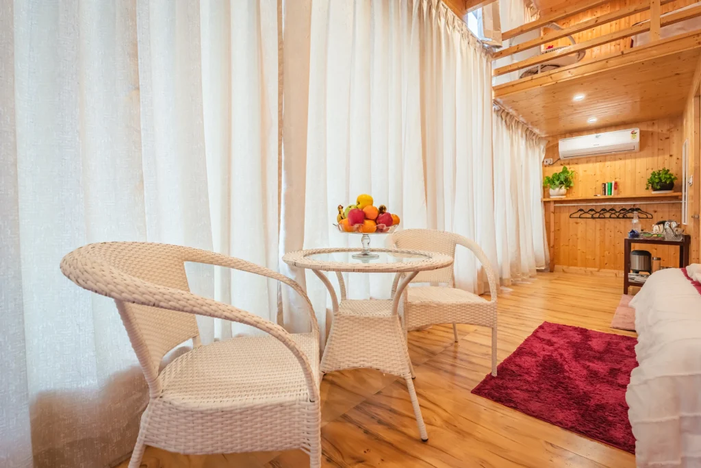 Best honeymoon resort in Dehradun with private romantic cottage, cozy seating area, wooden interiors and peaceful forest stay for couples