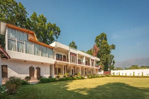 Luxury stay at Pristine Woods, the best resort in Dehradun, featuring spacious rooms surrounded by lush green lawns and nature
